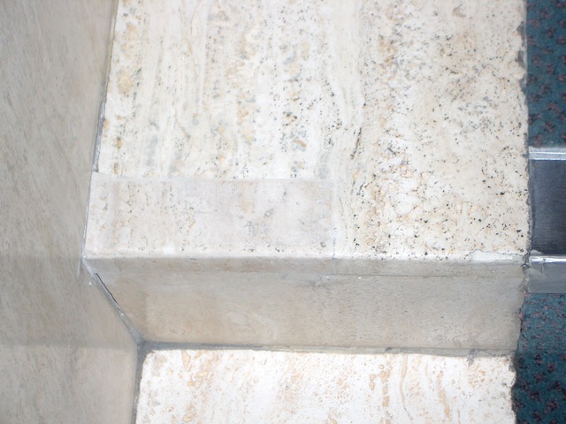 A Travertine step repaired with a matching piece of stone