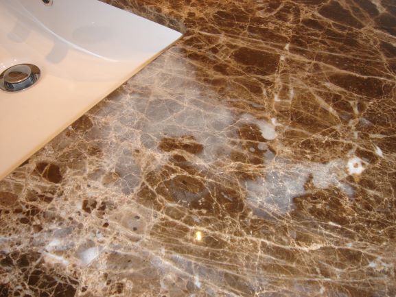 Etching on a marble vanity top caused by soapy water and tooth paste etc