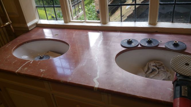 Marble vanity top with the right side polished with a 600 grit abrasive and the left side polished with a 6000 grit abrasive