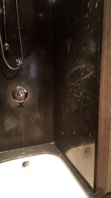 Marble shower with etch marks caused by various cleaning agents
