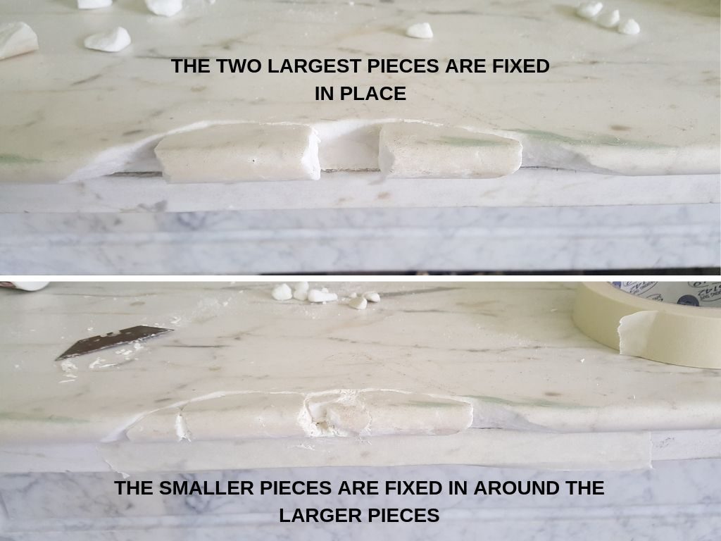 Repairing a large chip on a fireplace shelf. The pieces of marble are fixed in place