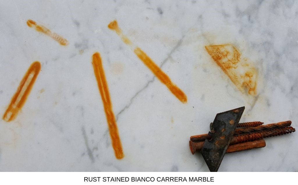 A piece of rust stained Bianco Carrera marble.